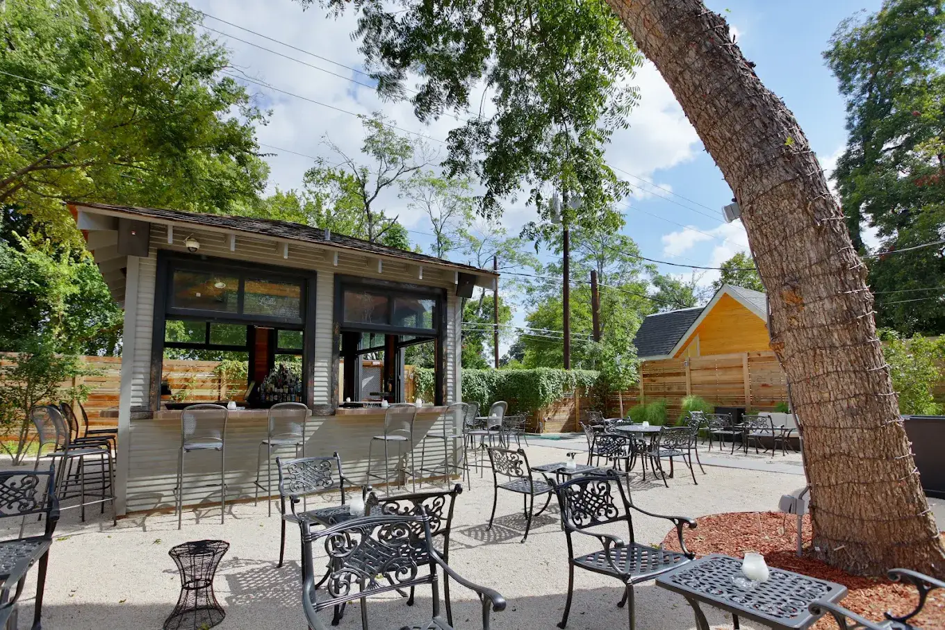 Lucille's backyard patio bar under shade trees in daylight